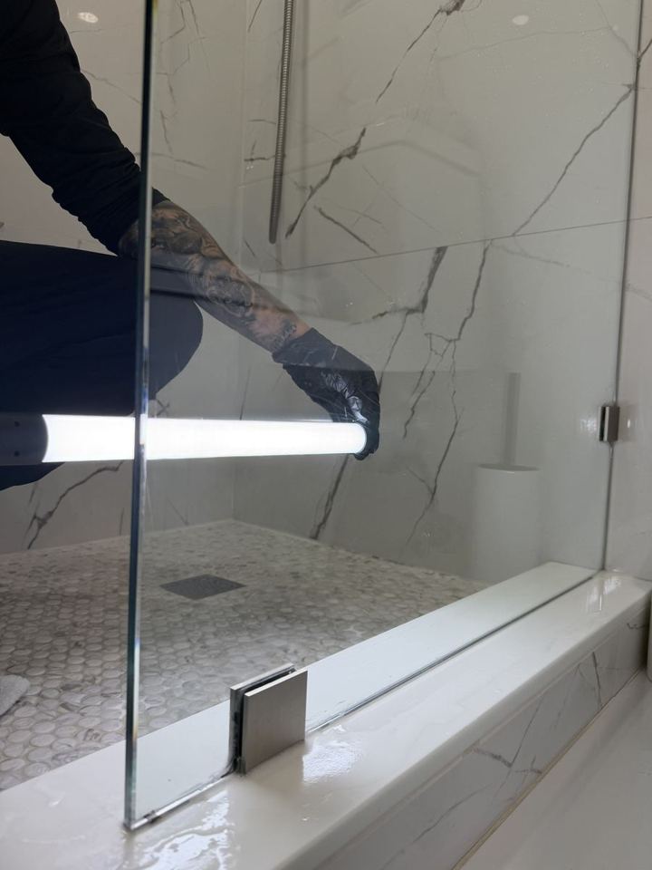 The same shower glass clear and spotless after hard water stain removal